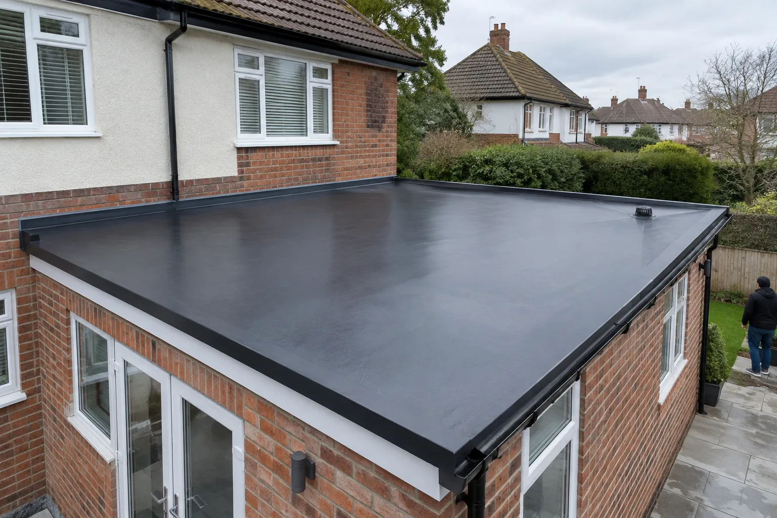 A black EPDM rubber flat roof on a house extension