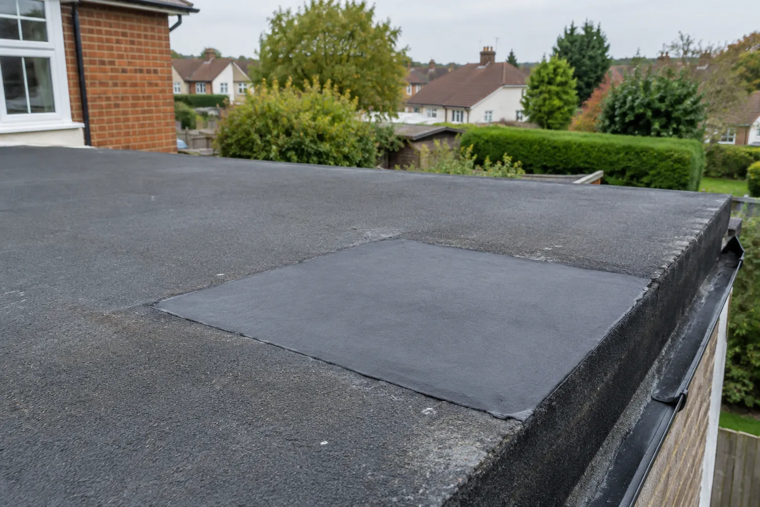 A patch repair bonded onto a flat roof membrane