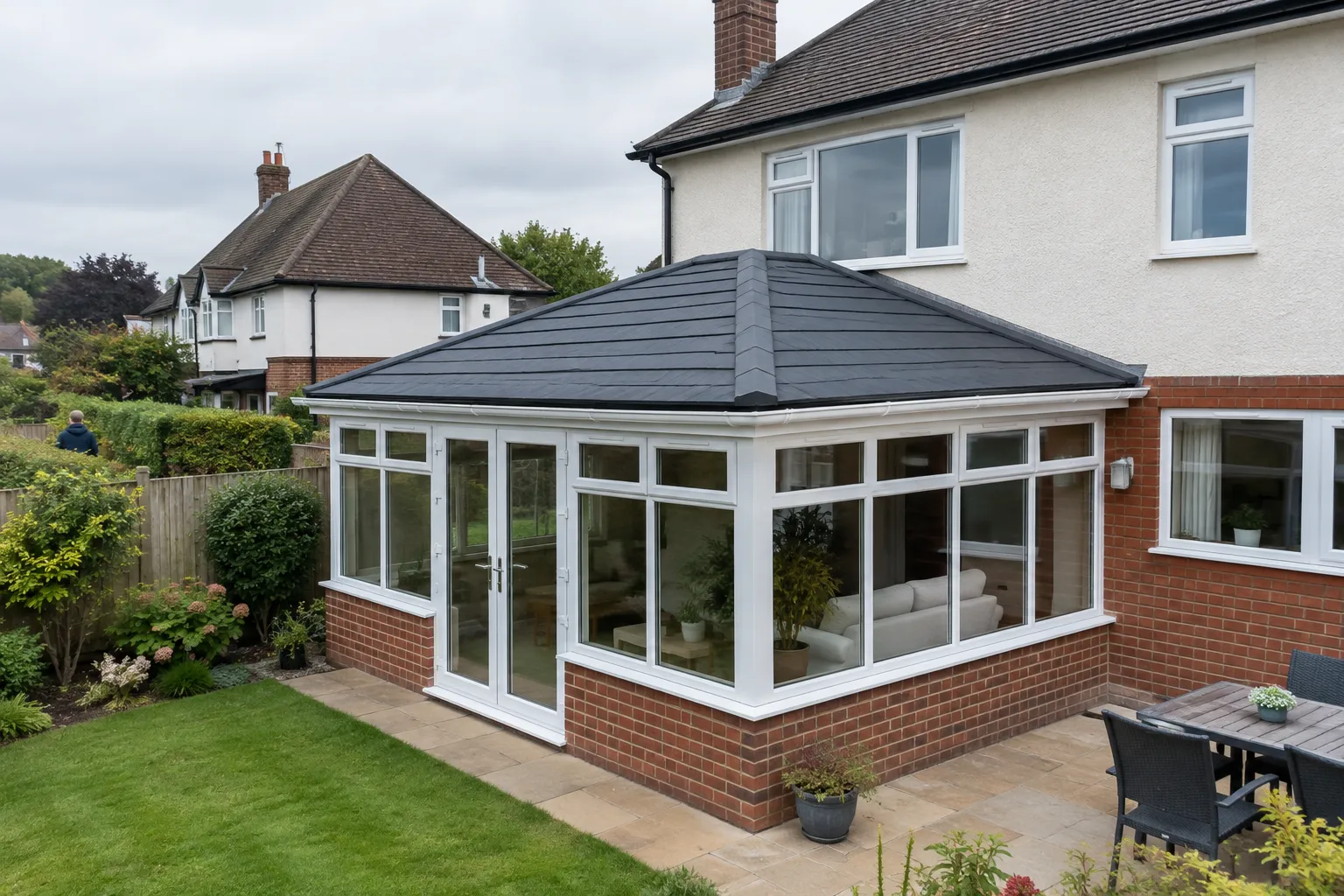 A conservatory with a solid insulated tiled roof