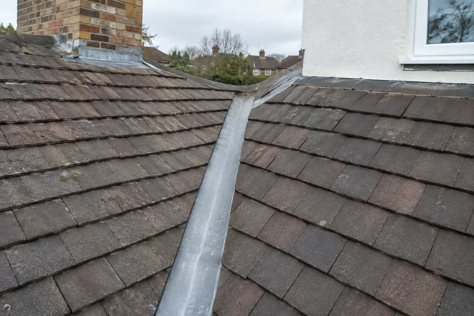 Flashing along a valley where two roof slopes meet